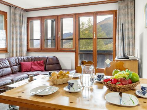 a living room with a table with fruit on it at Apartment Aragon M88 by Interhome in Ernen