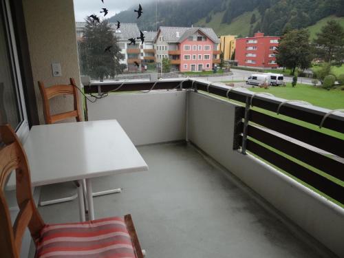a balcony with a table and a view of a city at Apartment Sunnmatt Süd Wohnung 432 by Interhome in Engelberg