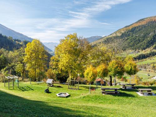 a park with benches and a playground in the mountains at Apartment Aragon M88 by Interhome in Ernen