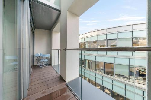 a balcony of an office building with a view of a table at Stylish and very central apartment with balcony in London