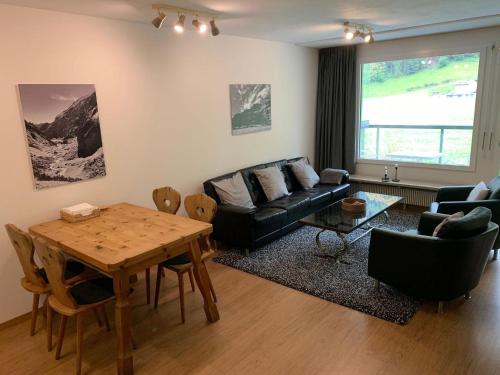 a living room with a couch and a table at Apartment Erlenrain Wohnung 722E by Interhome in Engelberg