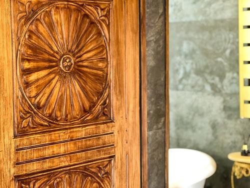 a wooden door in a bathroom with a toilet at La Mia Amore in Kotor