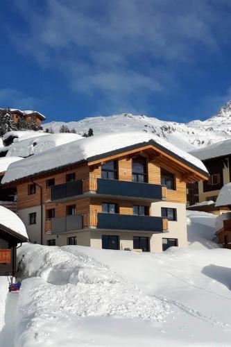 a snow covered apartment building with snow on the roof at Apartment Robert EG Süd by Interhome in Bettmeralp