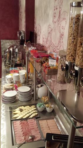 a buffet line with meat and other food items at Mercure Paris Bastille Marais in Paris