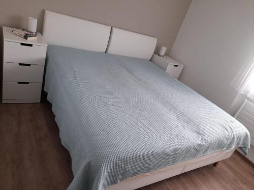 a bedroom with a bed and a dresser at Apartment Erlenrain Wohnung 911 by Interhome in Engelberg