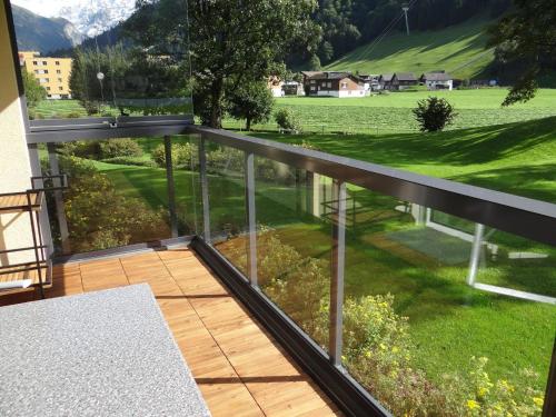 a balcony with a view of a green field at Apartment Erlenrain Wohnung 911 by Interhome in Engelberg