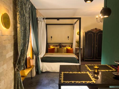 a bedroom with a bed and a table in a room at La Mia Amore in Kotor