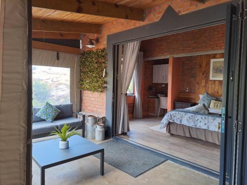 a bedroom with a bed and a large mirror at Helpmekaar Farm in Kareedouw