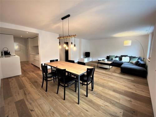 a dining room and living room with a table and chairs at Apartment Uehlinger Rosana by Interhome in Lenzerheide