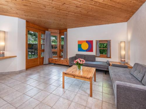 a living room with a couch and a table at Apartment Schweizerhof 502 by Interhome in Lenzerheide