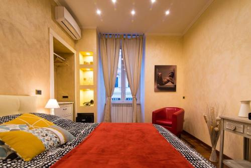 a room with a bed, a dresser and a painting on the wall at B&B Arco Di Gallieno in Rome