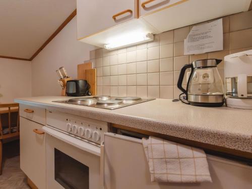 a kitchen with a stove and a counter top at Apartment Wildkogel 1 by Interhome in Neukirchen am Großvenediger