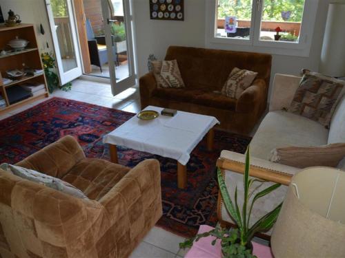 a living room with couches and a coffee table at Apartment Hübeli - Arm by Interhome in Zweisimmen
