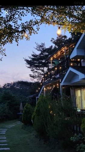 a house with lights on the side of it at Gozneok spacious private house - 75py in Goseong