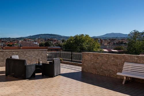 a balcony with a bench and a view of a city at a casa di Ma Gi in Ciampino