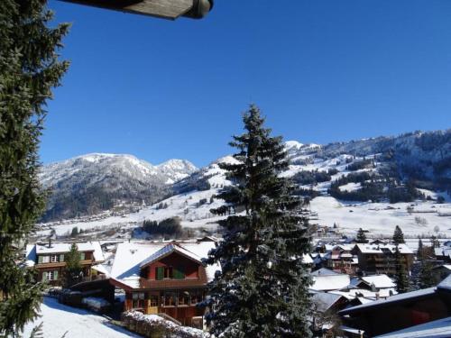 a view of a ski resort with a snow covered mountain at Apartment Kristall by Interhome in Zweisimmen
