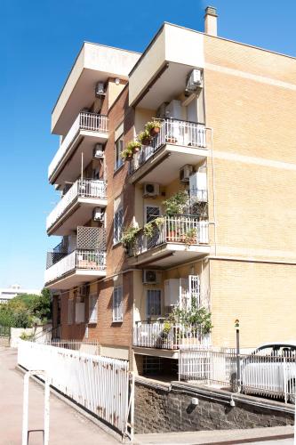 an apartment building with balconies and plants on it at a casa di Ma Gi in Ciampino