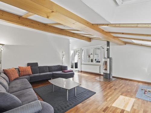a living room with a couch and a table at Apartment Hutter by Interhome in Churwalden