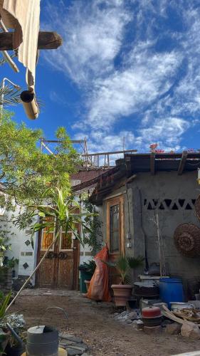 a house with a woman standing in front of it at Andyvone at yvone in Dahab