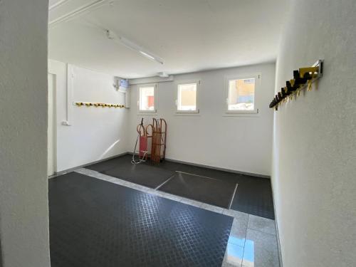 an empty room with a white wall and a room with tools at Apartment Hutter by Interhome in Churwalden