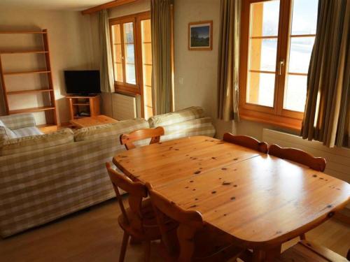 a living room with a wooden table and a couch at Apartment Jacqueline 2 by Interhome in Gstaad