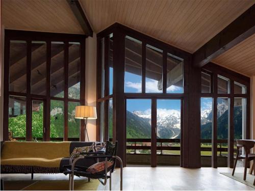 a room with a large window with a view of mountains at Apartment Am Dürrbach 2-244 by Interhome in Engelberg