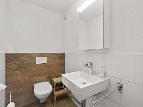 a bathroom with a white sink and a toilet at Apartment Triangel D Paijmans by Interhome in Parpan