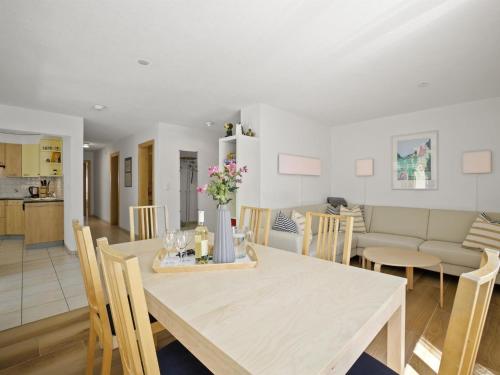 a dining room and living room with a table and chairs at Apartment Ruggli by Interhome in Churwalden