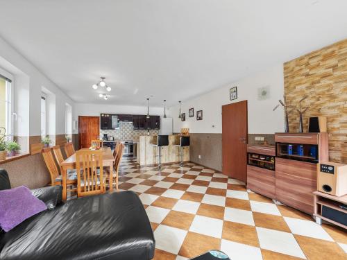 a living room and kitchen with a couch and a table at Holiday Home Jílové by Interhome in Jílové