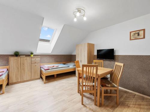 a room with a table and chairs and a bed at Holiday Home Jílové by Interhome in Jílové