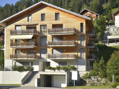 an apartment building with balconies on the side of a mountain at Apartment Raber by Interhome in Churwalden