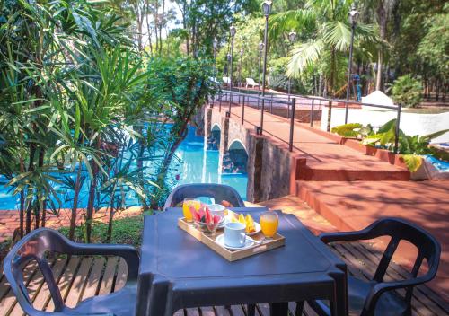 a blue table with a tray of fruit and drinks at El Leñador by DOT Cabana in Puerto Iguazú