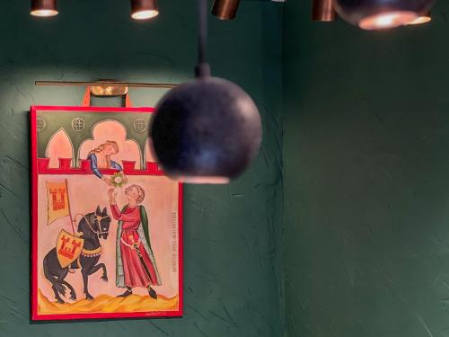 a picture of a woman with a ball hanging on a wall at La Mia Amore in Kotor