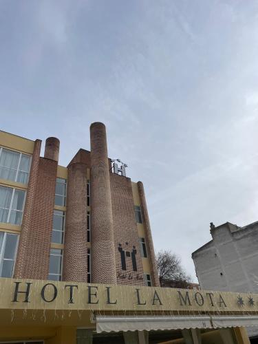a building with two towers on top of it at Hotel La Mota by Punta25 Hotels Group in Medina del Campo