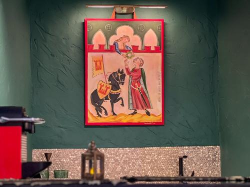 a picture hanging on a green wall with a picture at La Mia Amore in Kotor