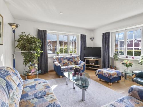a living room with two couches and a tv at Apartment van der Meij by Interhome in Churwalden