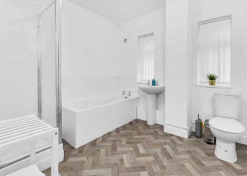 a white bathroom with a toilet and a sink at Elegant 3 Bedroom Detached House By Your Lettings Short Lets & Serviced Accommodation Peterborough With Free WiFi & Parking in Brampton Grange