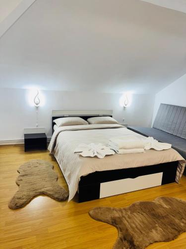 a bedroom with a large bed and a rug at Casa Montana in Predeal