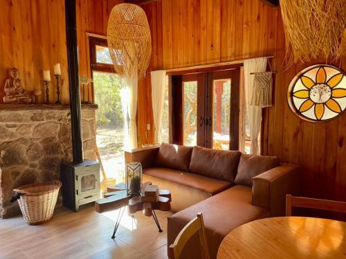 a living room with a couch and a stove at Ser Monte Hospedaje in La Población