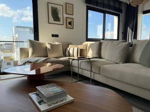 a living room with a couch and a table at Zephyros in Alsancak