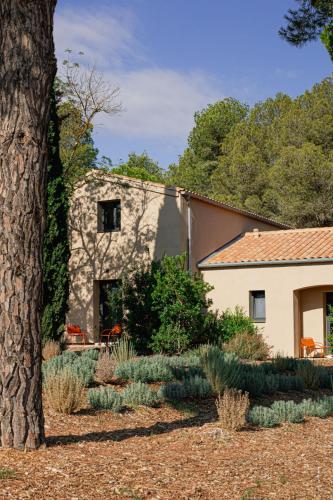 a house with a tree in front of a yard at Les Villas du Château de Lastours in Portel-des-Corbières
