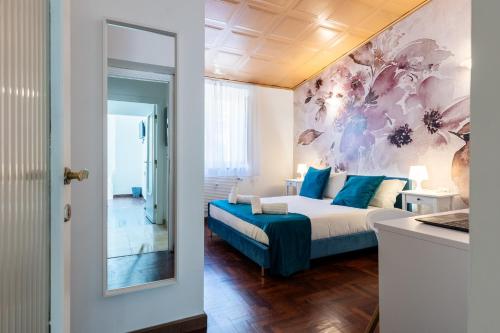 a bedroom with a bed and a painting on the wall at Fantastic Rome Guest House in Rome