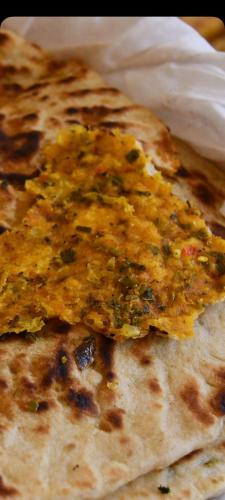 a close up of a piece of food on a tortilla at Auberge La Fibule Du Dades in Aït Idaïr