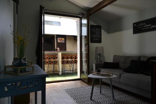 a living room with a couch and a table at Le gite de la Lombriere in Saint-Denis-de-Pile