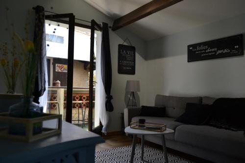 a living room with a couch and a table at Le gite de la Lombriere in Saint-Denis-de-Pile