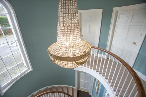 a chandelier hanging over a staircase in a house at Ivy Guest house in Hawkshead