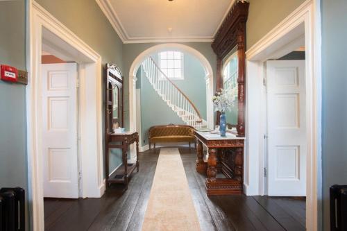 a hallway with white doors and a staircase in a house at Ivy Guest house in Hawkshead