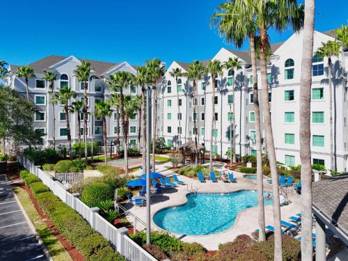 an aerial view of a resort with a pool and palm trees at 3 beds DisneyFree Shuttle in Orlando