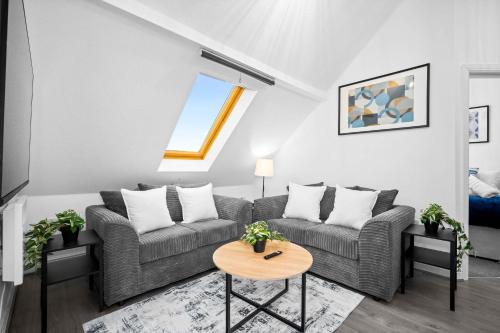 a living room with a couch and a table at Modern Apartment - Accommodates 4 - On Street Parking Available 2CR in Birmingham