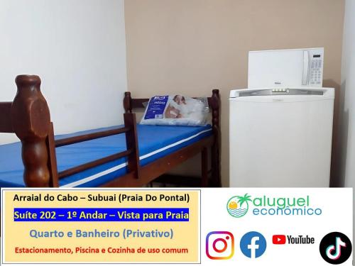 a dog laying on a bed next to a refrigerator at Arraial do Cabo – Subuai Village - Aluguel Econômico in Arraial do Cabo